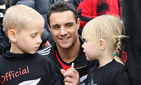 Daniel Carter signs an autograph for young fans