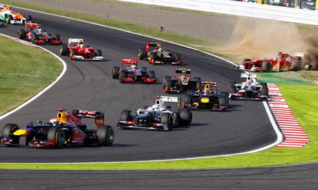 Sebastian Vettel leads into the first corner as Fernando Alonso spins out of the race