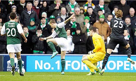 Hibernian's Leigh Griffiths, second left, scores the opening goal