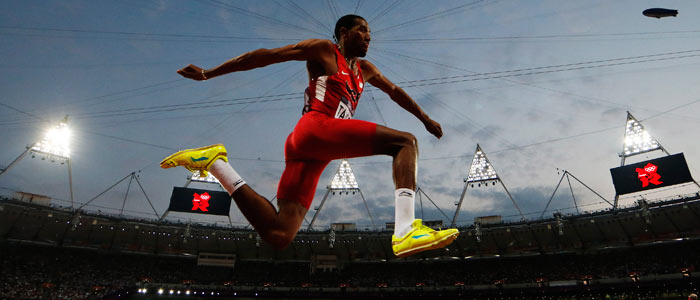 Christian Taylor leaps against a dramatic sky on his way to the men's triple jump title