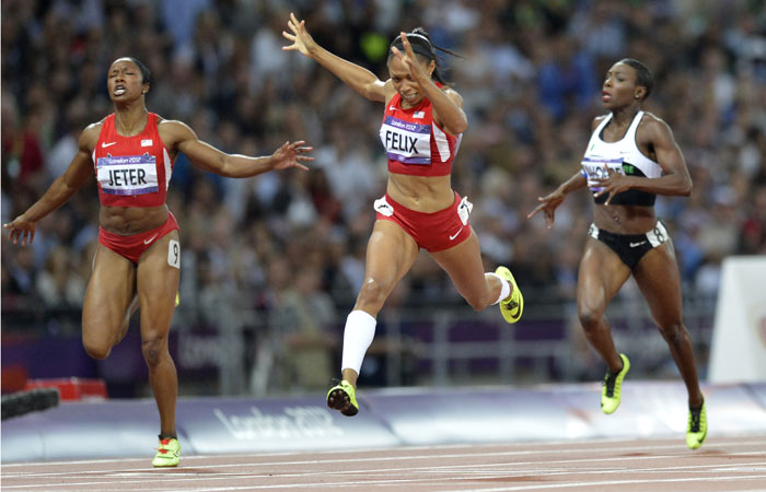 Allyson Felix reacts as she wins the 200m ahead of Carmelita Jeter, left