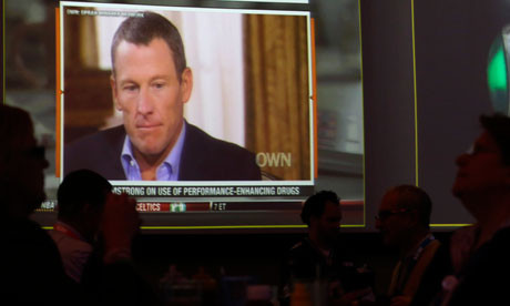 A video screen at a hotel restaurant shows Lance Armstrong