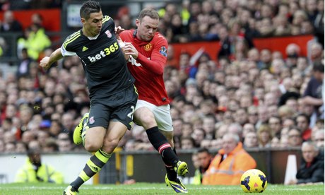 Manchester United's Wayne Rooney, right, and Stoke City's Geoff Cameron in the Premier League