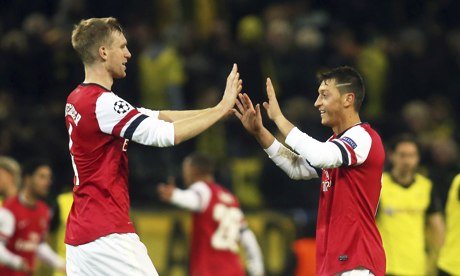 Arsenal's Per Mertesacker, left, and Mesut Ozil