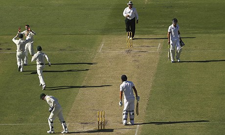 Nathan Lyon of Australia celebrates after taking the wicket of Alastair Cook