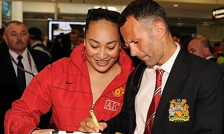 Manchester United's Ryan Giggs signs a shirt for a United fan in Sydney