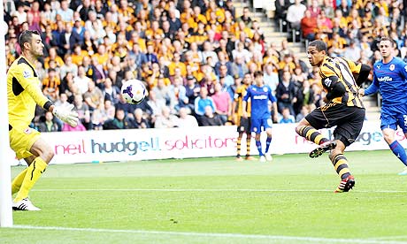 Curtis Davies, second right, scores for Hull City against Cardiff City in the Premier League