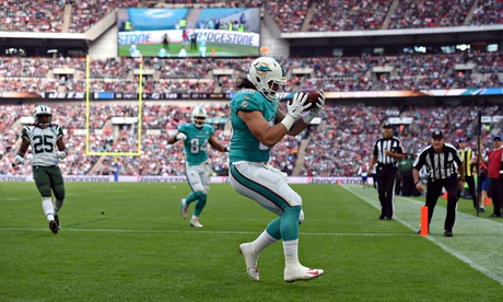 Jake Stoneburner of the Miami Dolphins scores a touchdown against the New York Jets at Wembley.