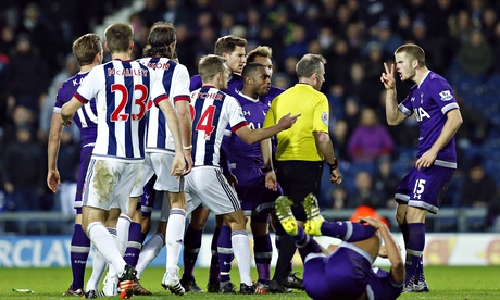 West Bromwich Albion and Tottenham Hotspur surround referee Jon Moss