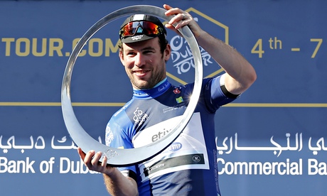 Mark Cavendish of Etixx-Quick-Step team celebrates on the podium with the Dubai Tour trophy. 