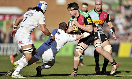 The young Harlequins flanker Jack Clifford is tackled by David Paice of London Irish.