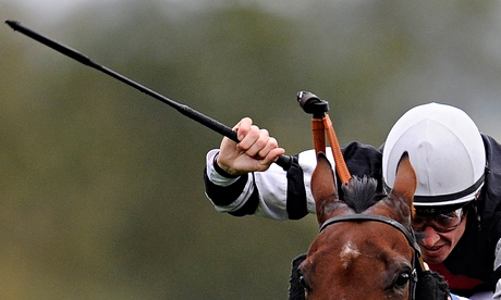 Jockey holds whip aloft