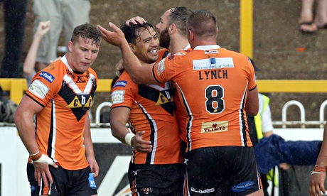 Denny Solomona, centre, is congratulated by Castleford team-mates after completing his hat-trick.