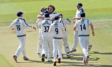 Ryan Sidebottom is mobbed by his Yorkshire team-mates 