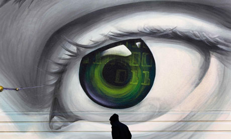 An immigrant walks past graffiti in an Athens