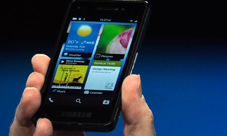 Thorsten Heins holds a prototype of the BlackBerry 10 