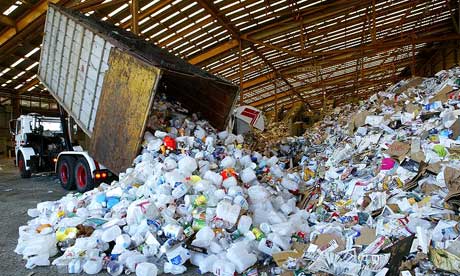 A truck dumps its load of plastic at a waste recycling facility