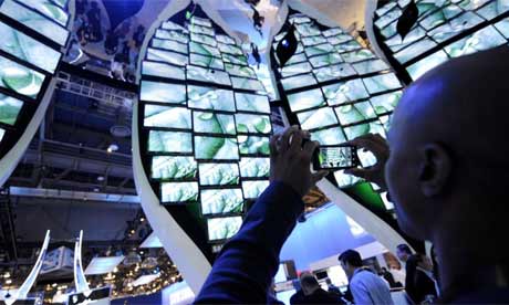 An attendee takes a picture of the Samsung booth at CES 2010