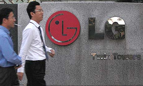 People walk past a LG Electronics logo at the company's headquarters in Seoul