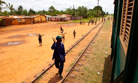 Locals wave at the train as it passes.