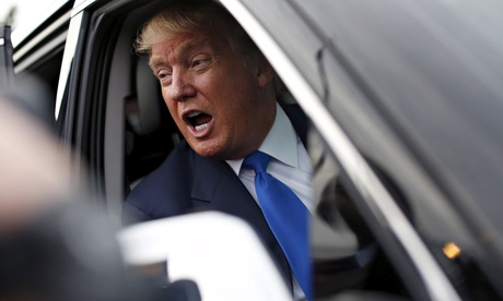 Trump speaks to the media through his SUV window after a rally in Manchester