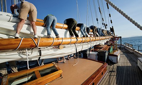 All hands on deck … crew members put away the sails.