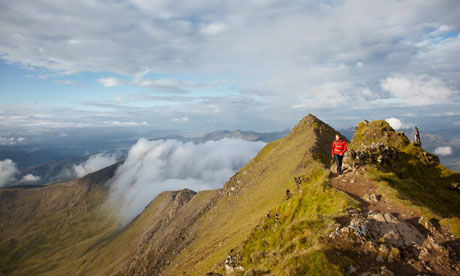 Hiker walking near the summit of Mount Snowdon.