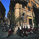 Motorbikes parked at the corner of a building