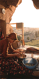 Woman preparing supper in a cave in the Goreme Valley