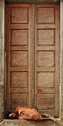 A Luandan street child, asleep in a doorway