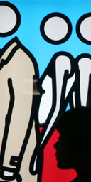 Shopper passes a Julian Opie mural in Tokyo