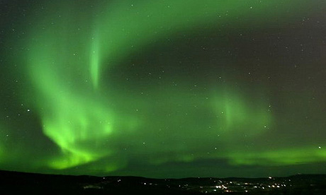 An aurora hangs over the Ester Dome Road area west of Fairbanks, Alaska