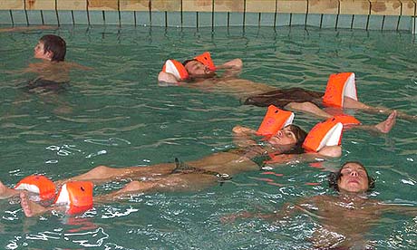 Festival goers float in a pool at the Aldrei event in Iceland