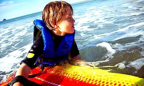 A child with a surfboard