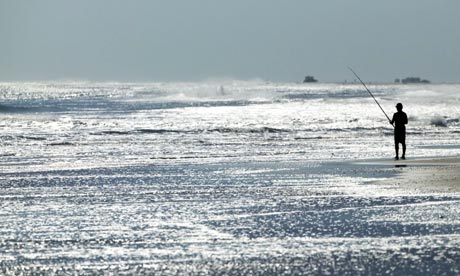Fisherman on Ocracoke beach, North Carolina, US