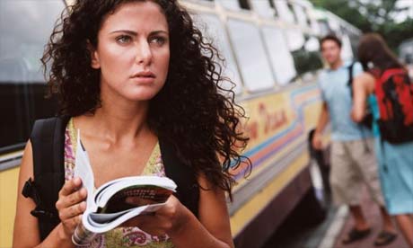 Traveller using a guidebook