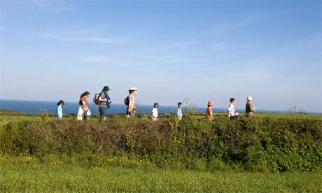 Two families hiking at the Lizard peninsula, UK. Photograph: Gideon Mendel