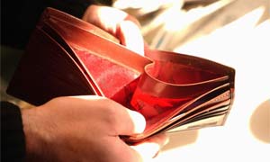 man looking at empty wallet