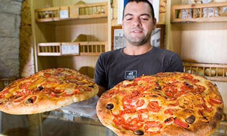 Baker showing his Focaccia in Cisternino, Italy