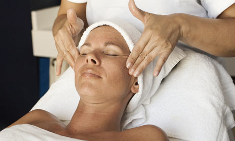 Woman getting a facial massage at a spa