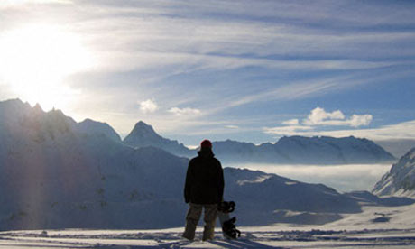 Snowboarder admiring the scenery at Tignes, France