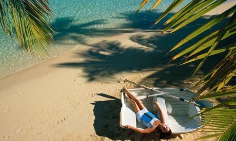 Woman sun bathing on a beach