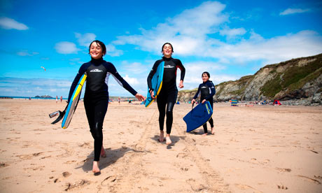 Beach Boys on Gwithian beach with Godrevy lighthouse in the distance