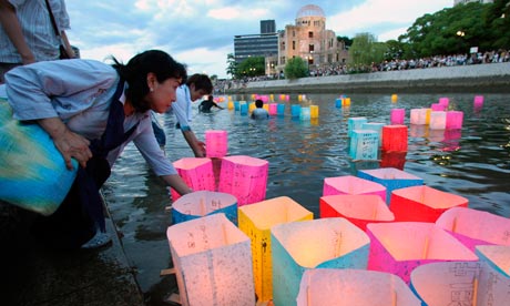 Candlelit lanterns float on the Motoyasu River