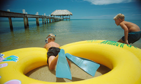 Two boys playing with raft on the beach