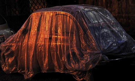 Fiat covered by plastic near the Tiber river in Rome