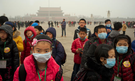 Children wear masks as a thick haze of air pollution envelopes Tiananmen Square in January. 