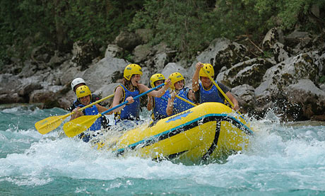 Group of children rafting on the river. Slovenia