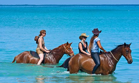 Horseriders in the sea at Buccoo Bay, Tobago.