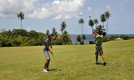 Two people play golf at Mount Irvine golf course, Tobago.